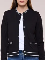 Cardigan tipo varsity negro de punto liviano, con cuello redondo, mangas largas y cierre frontal de botones. Presenta detalles de líneas blancas en el cuello, los bolsillos simulados y el ruedo elástico acanalado.