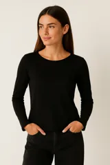 Remera de manga larga, color negro, de corte ajustado al cuerpo y cuello redondo.