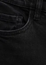 Jeans mom fit de tiro alto y corte recto, confeccionados en denim negro con tejido elástico. Cuentan con diseño clásico de cinco bolsillos, trabillas para cinturón y cierre frontal con cremallera y botón metálico.