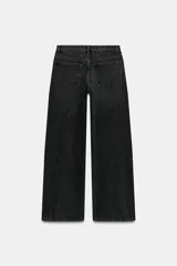 Jeans de tiro medio con diseño de cinco bolsillos y pierna ancha. Presenta un corte recto y holgado con bajo acabado sin costuras y cierre frontal con cremallera y botón metálico.