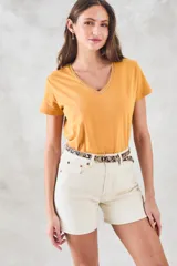 Remera de algodón color mostaza, de manga corta y escote en V con detalle metalizado.