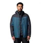 Campera 3 en 1 Columbia con sistema Interchange, compuesta por una capa exterior impermeable y transpirable con tecnología Omni-Tech y una capa interior aislante con forro termorreflectante Omni-Heat. Presenta diseño bicolor en azul y gris oscuro, capucha ajustable, ventilación en axilas, faldón para nieve y múltiples bolsillos con cierre.