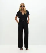 Pantalón de sastrería corte recto confeccionado en crepé, con trabillas en la cintura, bolsillos traseros y cinto fino incluido.