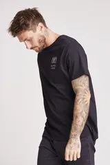 Remera blanca de manga corta con cuello redondo y un pequeño estampado azul en el pecho.