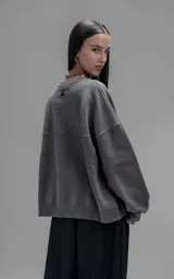 Buzo de cuello redondo confeccionado en frisa de algodón, con diseño de hombros caídos y logo bordado en el frente. Presenta terminaciones en punto rib en cuello, puños y ruedo.