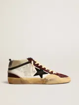 Championes de caña media Golden Goose modelo Mid Star, con base blanca, puntera y detalles en cuero color bordó. Presentan la estrella lateral en negro, cordones color crema y suela con efecto desgastado.