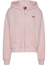 Buzo Tommy Jeans color rosa con capucha, cierre frontal y logo bordado en el pecho. Confeccionado en algodón regenerativo de peso pesado.