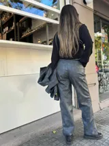 Pantalón gris de cuero sintético con corte recto y tiro alto.