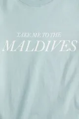 Remera de algodón color verde menta, con cuello redondo y estampa frontal con la frase 'Take me to the Maldives' en color blanco.