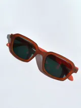 Lentes de sol negros con marco cuadrado y lentes grises.