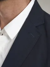 Blazer color marrón claro, de corte clásico, con solapas de muesca, cierre de dos botones, bolsillo en el pecho y bolsillos laterales con solapa.