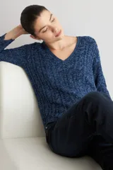 Sweater de punto con cuello en V y mangas largas, confeccionado en un tejido con textura de rayas verticales en tonos azulados.