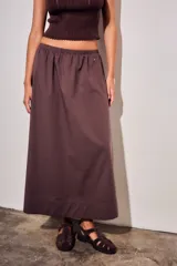 Falda midi de corte recto y diseño minimalista, confeccionada en algodón peinado. Presenta cintura elástica con frunces y un dobladillo ancho en la parte inferior.