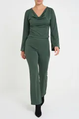 Pantalón de corte recto y tiro alto, confeccionado en tejido elastizado color verde oliva, con costuras frontales verticales que estilizan la silueta.