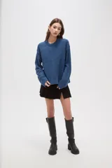 Sweater de tejido de punto color azul, con cuello redondo, manga larga y diseño holgado.