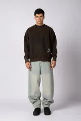 Buzo de cuello redondo con efecto desgastado, de calce oversize y mangas largas. Presenta un pequeño logo estampado en la parte inferior frontal y una etiqueta pequeña en el puño.