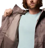 Campera impermeable Columbia modelo Hikebound II, color gris, con capucha ajustable y cierre frontal. Presenta el logo de la marca bordado en el pecho.