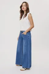 Jean wide leg de tiro medio, con pierna amplia de caída recta, diseño de cinco bolsillos, pasacintos y cierre frontal con botón y cremallera.