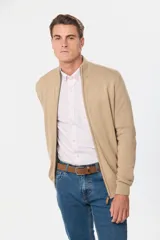 Campera tejida de algodón azul con cierre frontal y cuello alto. Corte clásico.