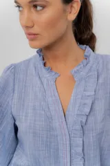 Camisa de manga larga color beige con diseño a rayas sutiles, cuello mao con volados y abertura frontal con detalles de volados a un lado.