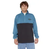 Buzo Rip Curl Heritage Oval 1/4 Zip Crew, color azul y negro, con cuello alto y cierre de un cuarto. Presenta el logo de la marca bordado en el pecho.