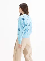 Buzo de algodón gris con estampa de abeja en el centro y diseño de flores oscuras dispersas por toda la prenda. Cuenta con cuello redondo, mangas largas y puños y cintura elastizados.