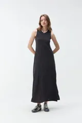 Vestido largo gris oscuro, sin mangas, con cuello redondo y silueta fluida.