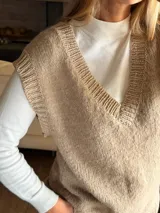 Chaleco tejido de punto jersey en mezcla de lana y mohair, con cuello en V y terminaciones acanaladas en escote, sisas y ruedo.