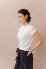 Remera tejida en seda fría color marrón, de calce relajado, cuello redondo y manga corta con terminación amplia.