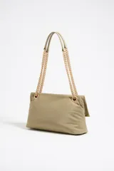 Bolso de hombro pequeño confeccionado en tejido técnico color verde oliva. Presenta solapa con cierre magnético, logo metálico LB en el frente y doble asa de cadena con detalles en piel. Incluye forro interior y relleno acolchado.