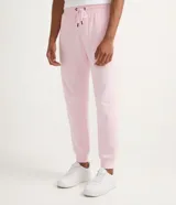 Pantalón deportivo de algodón y poliéster color rosa claro, con cordón ajustable en la cintura y puños elásticos en los tobillos.