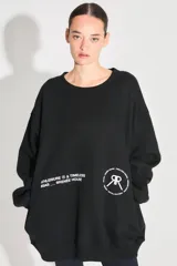 Buzo oversize negro de frisa con cuello redondo, hombros caídos, bolsillos delanteros y estampa serigráfica en delantero y espalda.
