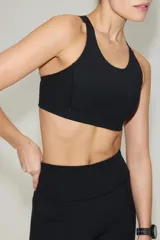 Top deportivo negro con tecnología ShapeMove y DryMove, de alto soporte, con copas forradas con relleno extraíble, breteles anchos ajustables y espalda nadadora de corte olímpico.