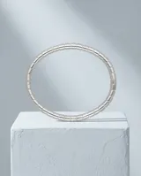 Pulsera esclava rígida de acero inoxidable, con diseño de eslabones cuadrados articulados que forman una estructura flexible y continua.
