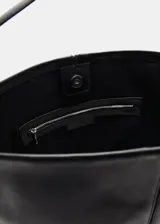 Bolso tipo shopper de cuero vacuno, color negro, con diseño minimalista, costura central vertical y asa de hombro ajustable con hebilla metálica.