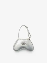 Minibolso charm Diesel Play con diseño inspirado en un control de videojuegos, confeccionado en material de acabado brillante color rojo. Presenta el icónico logo metálico Oval D en el frente y un gancho superior tipo llavero con correa.