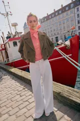 Trench corto de Zara confeccionado en piel de ante, con cuello de solapa, cierre frontal cruzado con botones, mangas largas con trabillas y bolsillos delanteros de vivo.
