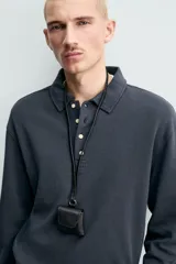 Polo de manga larga con corte regular fit, confeccionado en tejido de algodón con acabado cepillado. Presenta cuello solapa y cierre frontal con botonadura.