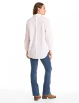 Camisa de corte oversize marca Grand & Greene, confeccionada en una mezcla de tencel, poliéster y elastano. Presenta cuello con solapa, cierre frontal con botones, mangas largas con hombros caídos y puños con botón. Incluye un bolsillo en el pecho, canesú trasero con tablón central y un bajo redondeado asimétrico, siendo más largo en la parte posterior.