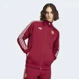 Campera deportiva Adidas de la selección de España, color bordó con las icónicas tres tiras blancas en las mangas. Presenta cuello chimenea, cierre frontal completo, bolsillos laterales y el logo del trébol junto al escudo de la selección en el pecho.