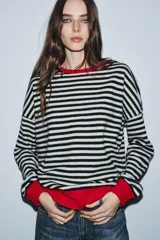 Jersey de lana 100% con rayas horizontales rojas y blancas, cuello redondo y puños y dobladillo en color marrón.