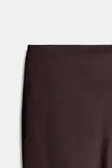 Falda midi negra de tejido satinado, corte recto y tiro alto con cintura elástica.