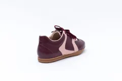 Zapatillas Magnolia de cuero negro con detalles en blanco y suela marrón.