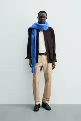 Pantalón chino de corte regular fit, confeccionado en tejido de algodón con elasticidad. Presenta bolsillos frontales, bolsillos traseros de vivo y cierre frontal con cremallera y botón.