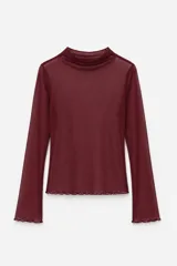 Blusa de tul color marrón, con cuello alto, mangas largas y terminaciones con borde ondulado.