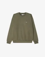 Buzo de algodón color verde oliva con cuello redondo, puños y cintura acanalados. Logo de la marca Obey bordado en el pecho.