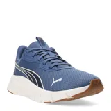Championes Puma Flexfocus Lite Modern de color azul, con diseño deportivo de malla textil y detalles sintéticos. Presenta el logo de la marca en el lateral y en la puntera, con una entresuela blanca de amortiguación ligera y suela de goma en tono caramelo.