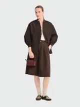 Cartera pouch Le Pliage de Longchamp, modelo compacto en color bordó con asa superior corta y cierre de solapa con botón a presión.