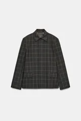 Blazer de corte recto con estampado de cuadros, cuello solapa y manga larga con hombreras. Presenta cierre frontal con botones ocultos bajo solapa y bolsillos delanteros con solapa.