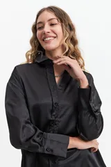 Camisa color verde oliva de manga larga confeccionada en tela satinada.